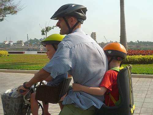 Father and two sons on  a bicycle