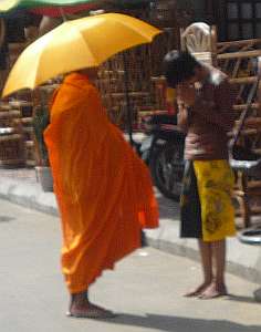 Young man giving alms