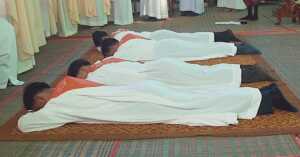 Deacons prostrate during litany of the saints