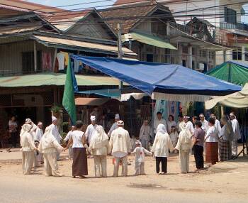 Funeral ceremony in street intersection