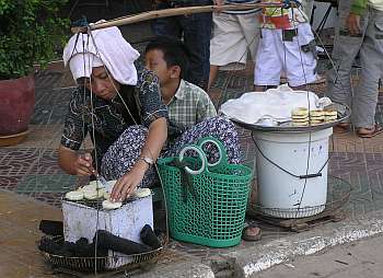 Mother and son selling a fried cake