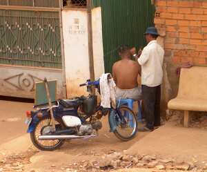 Street barber in Phnom Penh