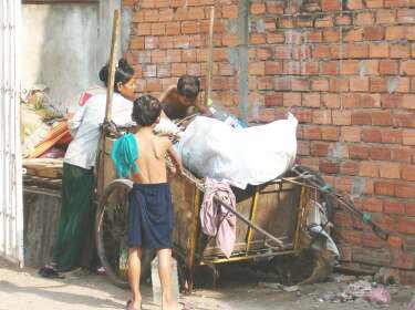 A mother and two sons collect trash for resale