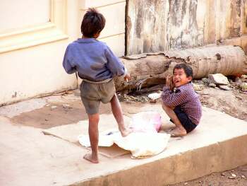 Two street kids playing in the road