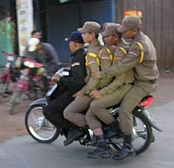 Five guards on a motorcycle