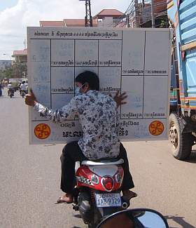 Carrying a lottery board on a motorcycle