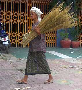 Elderly woman with brooms