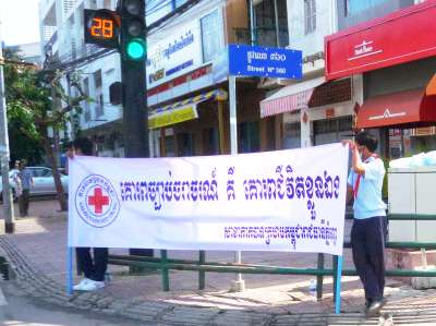 Red Cross youth with traffic sign