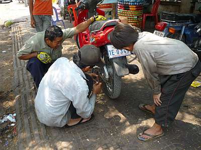 Reparing a motorcycle taxi