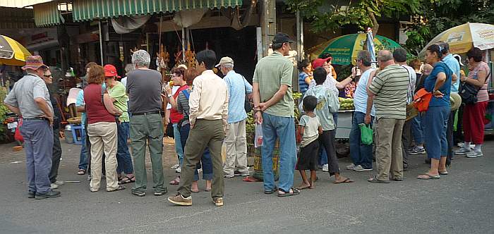 Tourists eating corn on the cob