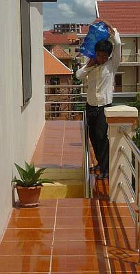 Man carrying water to 4th floor