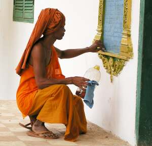 Monk doing maintenance work at a wat