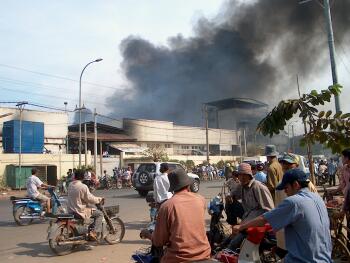 A factory set on fire by rioters in Phnom Penh