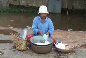 A woman selling cooked rice