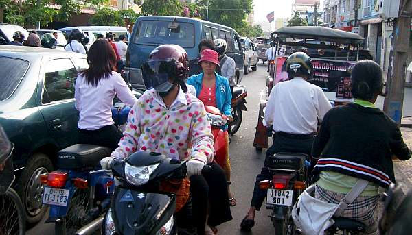 Motorcycles driving the wrong way through traffic