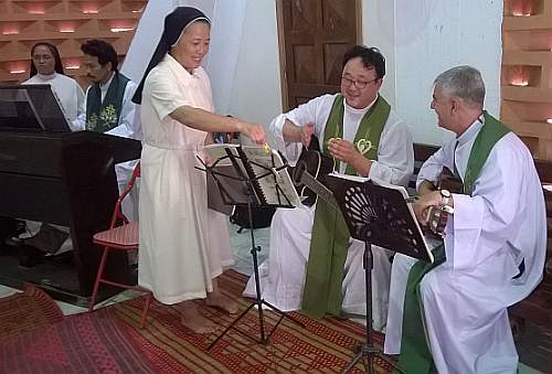 Bishop Kike playing guitar