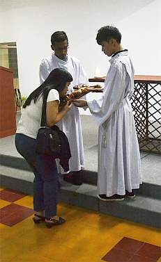 Woman venerating the cross
