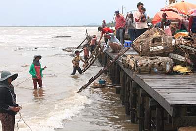 Retrieving crab cages from the surf