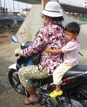 Boy on moto with his mother
