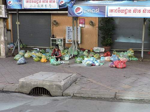 Preparing vegetables on the sidewalk