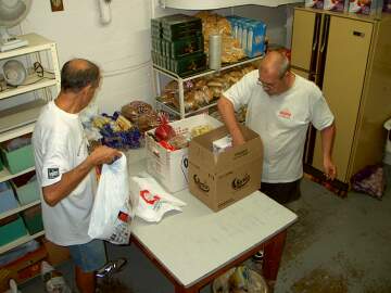 Two deaf men preparing food for the poor