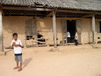 A student in front of the building with the deaf classroom
