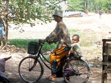A mother and baby on a bicycle