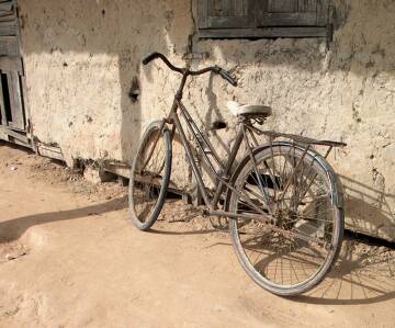 An old bicycle against an old wall