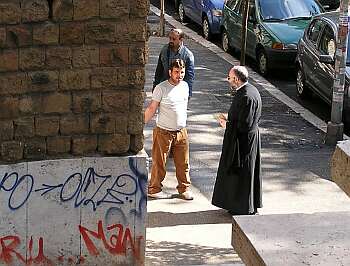A priest in cassock on the street
