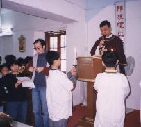Priest reading the gospel