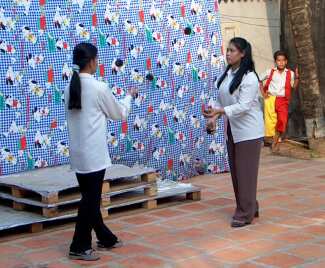 Two girls juggling together