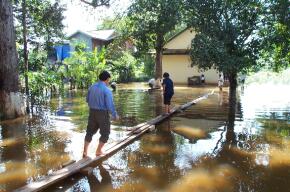 Walking on boards above the flood waters