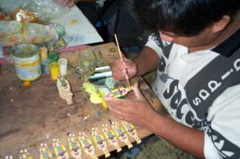 A deaf worker producing handicraft items