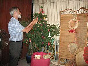 Charlie decorating the McLaughlins' Christmas tree