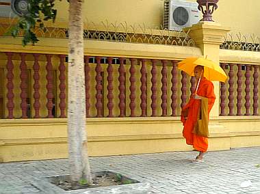 Monk walking on sidewalk