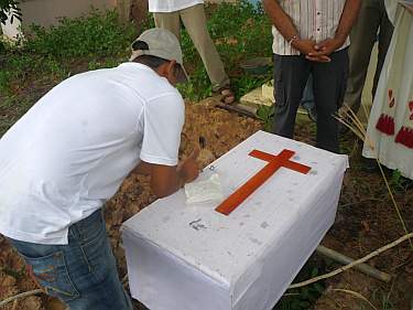 Placing the coffin on the grave