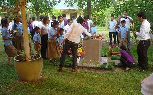 Students placing flowers on the memorial