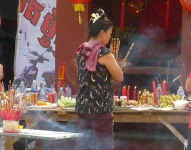 Praying at a street shrine