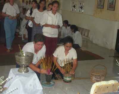 Placing incense before Joyce's photograph
