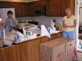 Mary and Hope setting up the kitchen