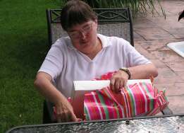 Ann opening a gift