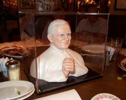 Pope John Paul II in the middle of the restaurant table