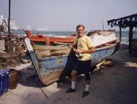 Charlie beside a Thai fishing boat