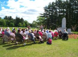 Outdoor mass in cemetery on Memorial Day